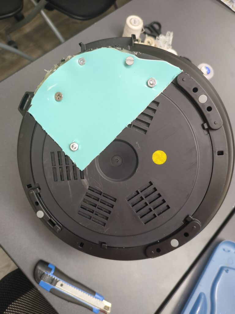 The same instantpot with the damaged area covered up with a custom cut piece of plastic.