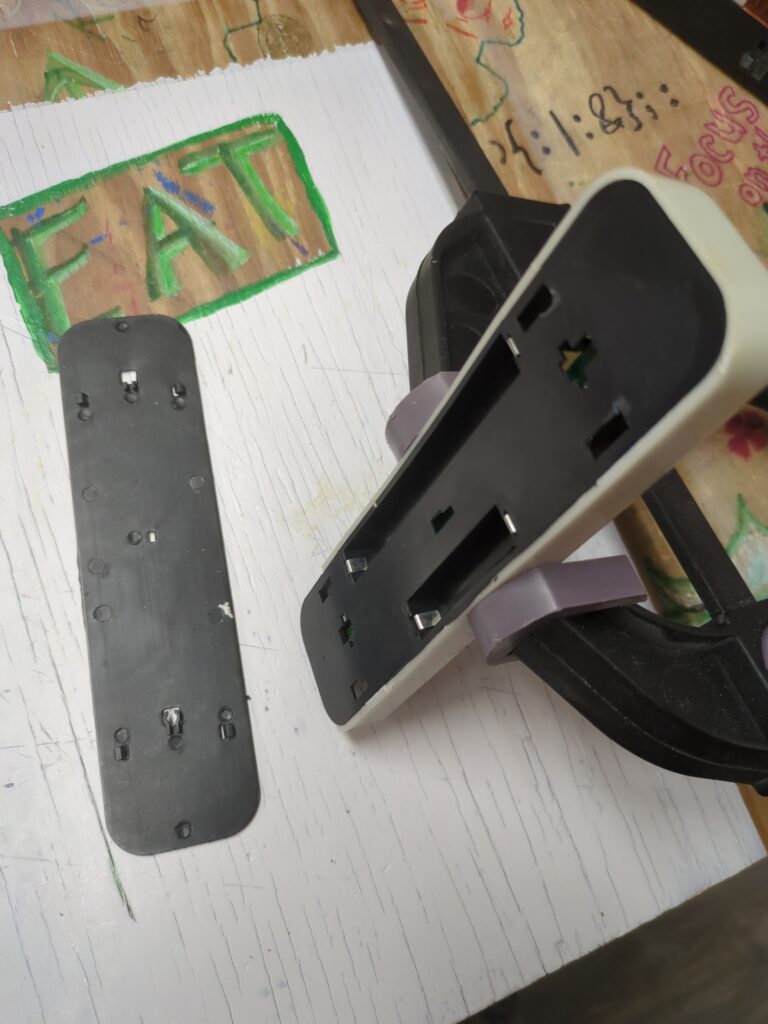 The back of an under-counter light which is clamped together